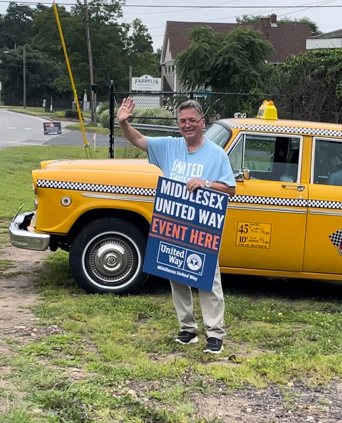 Kevin Reich waves to drivers on Route 66