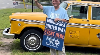 Kevin Reich waves to drivers on Route 66